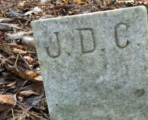 gravestone marked with the initials "J D C"