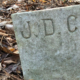gravestone marked with the initials "J D C"