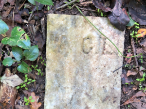 gravestone marked with the initials "A C L"